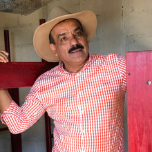 Load image into Gallery viewer, Guadalupe 'Beto' Reyes amongst coffee drying beds at El Limon in Palencia, Guatemala
